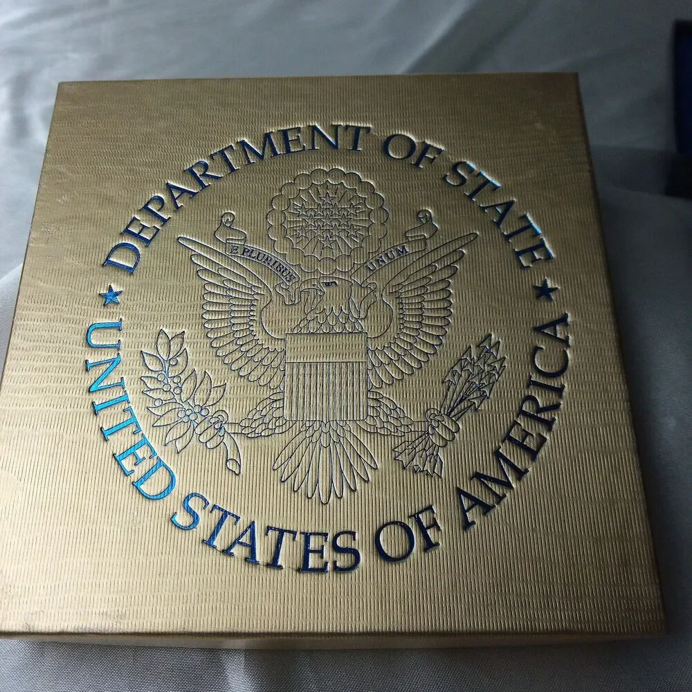 DEPARTMENT OF STATE GOLD TONE ORNAMENT IN BOX